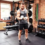 A professional home gym setup featuring a focused man exercising with a dumbbell set with rack.