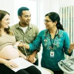 Pregnant woman checking her blood sugar levels to maintain a healthy gestational diabetes diet.