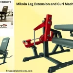 Mikolo leg extension and curl machine with weight plates setup in a compact home gym.