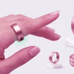 A Rose Gold RingConn Gen 2 smart ring shown being worn on an index finger with green PPG sensors glowing, alongside close-up shots of its inner optical sensors and matching metallic portable charging case.